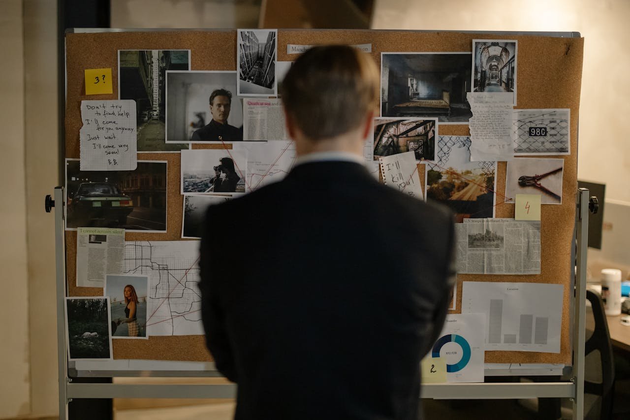 ours-journey Detective examining clues on a bulletin board filled with photos and notes.